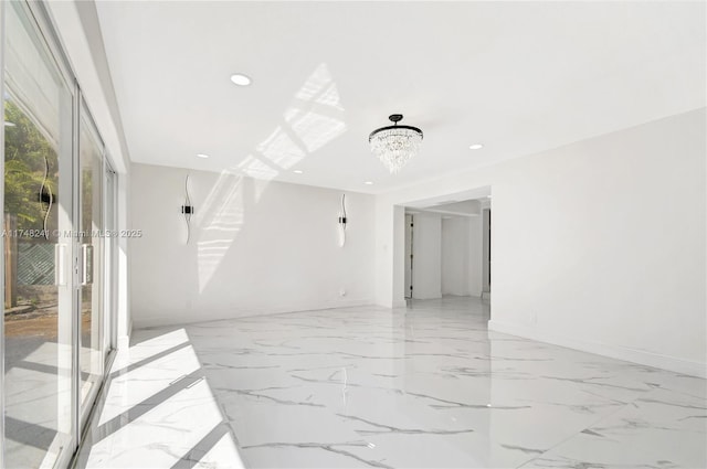 empty room with recessed lighting, baseboards, marble finish floor, and an inviting chandelier