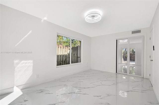 spare room featuring visible vents and marble finish floor