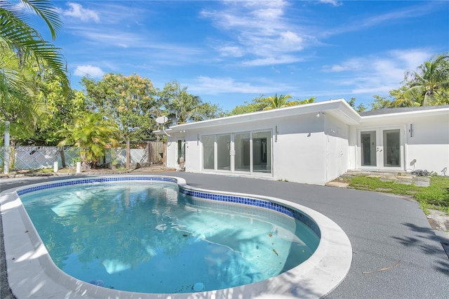 view of pool featuring a fenced in pool, french doors, a patio, and fence