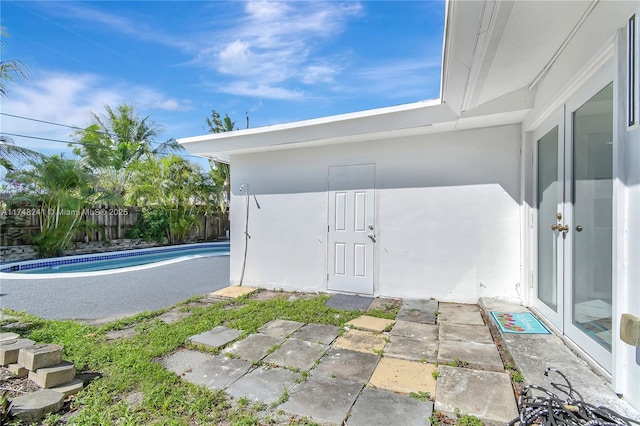 view of outbuilding with a fenced in pool and fence