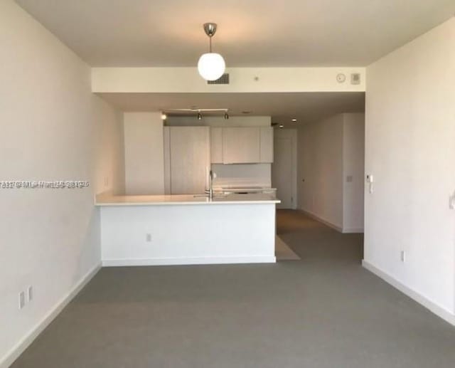 interior space featuring a sink, visible vents, and baseboards