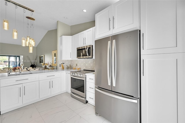 kitchen with stainless steel appliances, a sink, white cabinets, marble finish floor, and hanging light fixtures