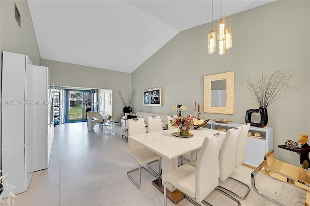 dining space featuring marble finish floor, visible vents, high vaulted ceiling, and a chandelier