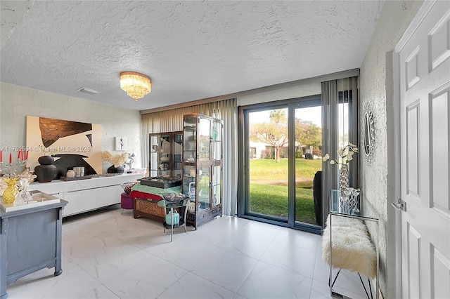 bedroom featuring a textured ceiling, a textured wall, visible vents, access to exterior, and marble finish floor