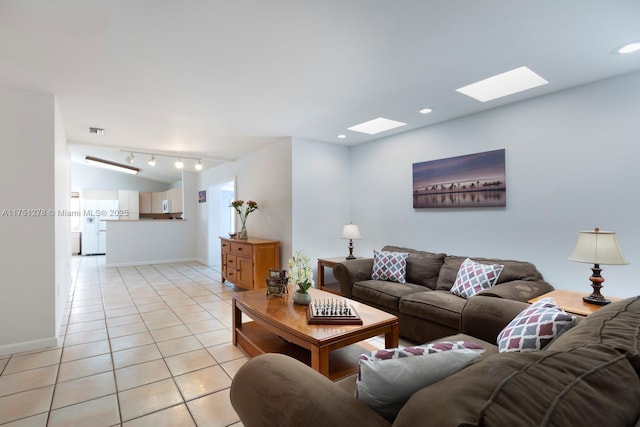 living room with light tile patterned floors, recessed lighting, washer / clothes dryer, visible vents, and baseboards