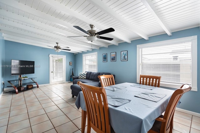 dining room with beam ceiling, light tile patterned flooring, and baseboards