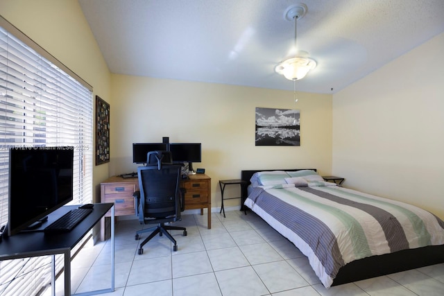 bedroom with light tile patterned floors and baseboards