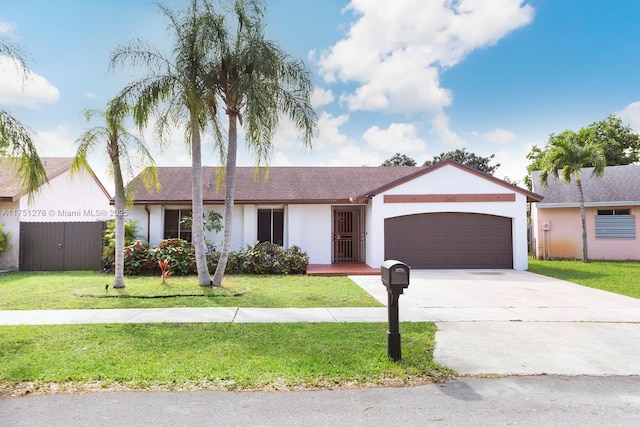 ranch-style home featuring a garage, fence, concrete driveway, stucco siding, and a front yard