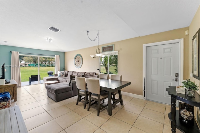 dining area featuring light tile patterned floors, visible vents, and baseboards