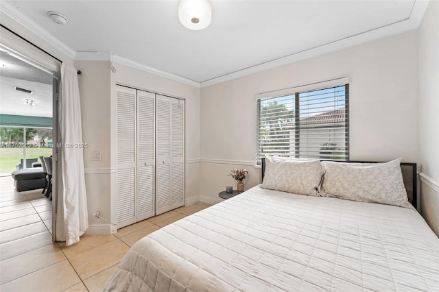 bedroom featuring light tile patterned floors, baseboards, access to exterior, a closet, and crown molding