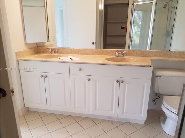 bathroom featuring a sink, toilet, and double vanity