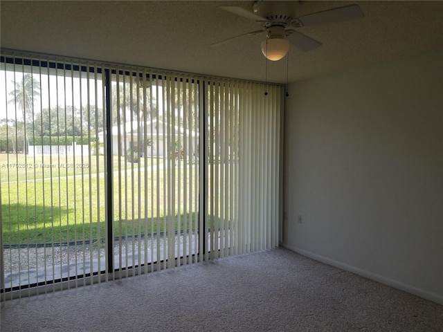 unfurnished room with carpet and ceiling fan