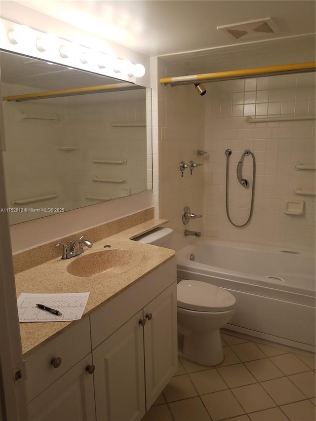 bathroom featuring toilet, vanity, visible vents,  shower combination, and tile patterned floors