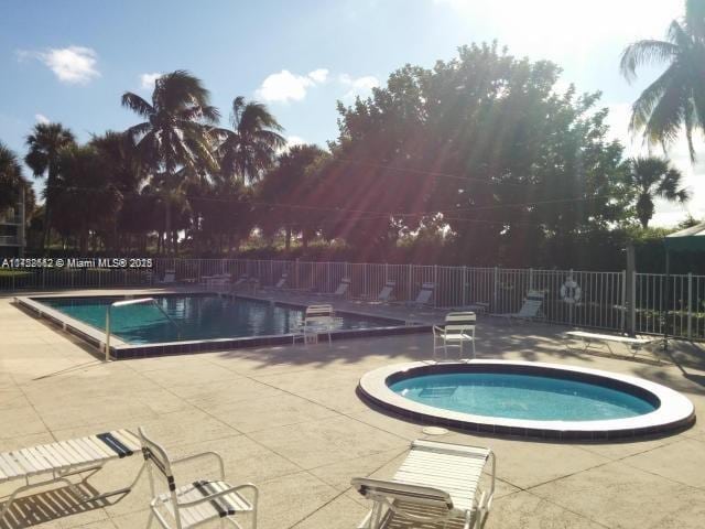 pool featuring a patio area and fence