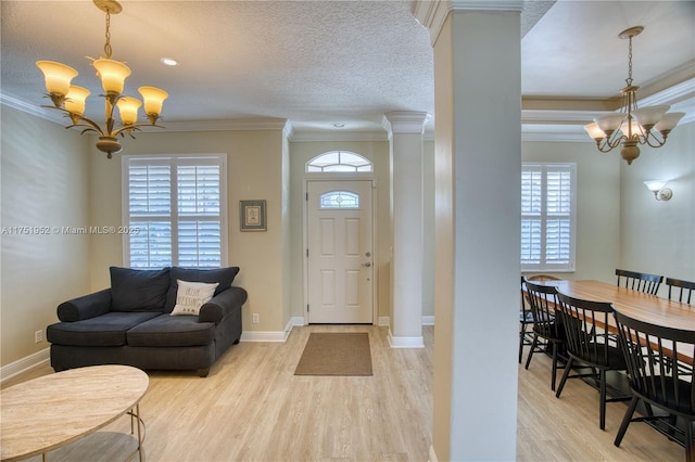 foyer entrance with an inviting chandelier and ornamental molding