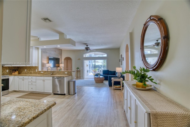 kitchen featuring a sink, open floor plan, range, light stone countertops, and dishwasher