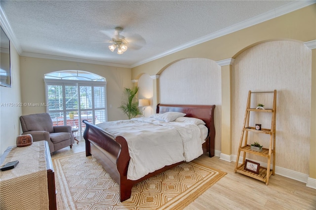 bedroom with a textured ceiling, ceiling fan, access to outside, ornamental molding, and light wood-type flooring