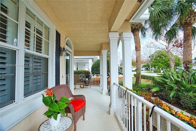 balcony featuring a sunroom and a porch