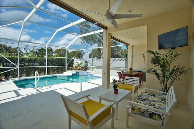 view of swimming pool with a fenced in pool, glass enclosure, a patio, and fence