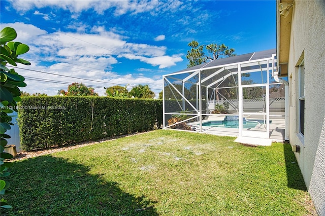 view of yard featuring glass enclosure, a fenced backyard, and a fenced in pool