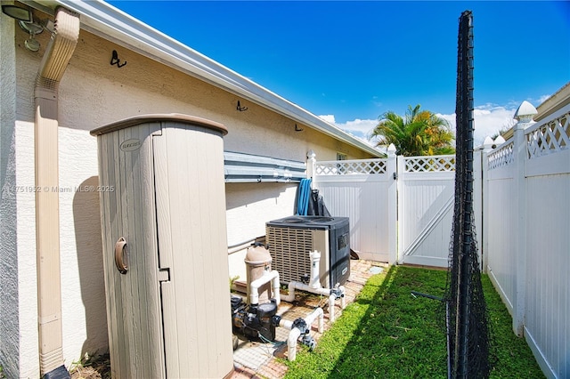 view of yard with cooling unit, a gate, and fence