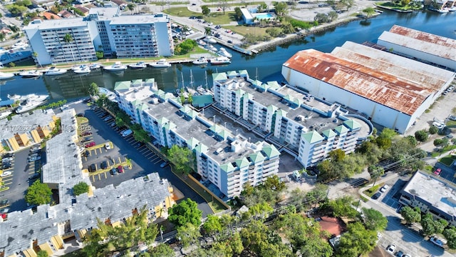 birds eye view of property with a water view and a view of city