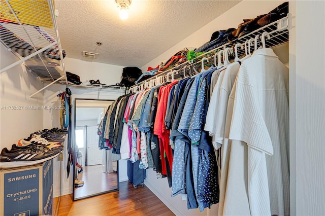 walk in closet featuring wood finished floors and visible vents