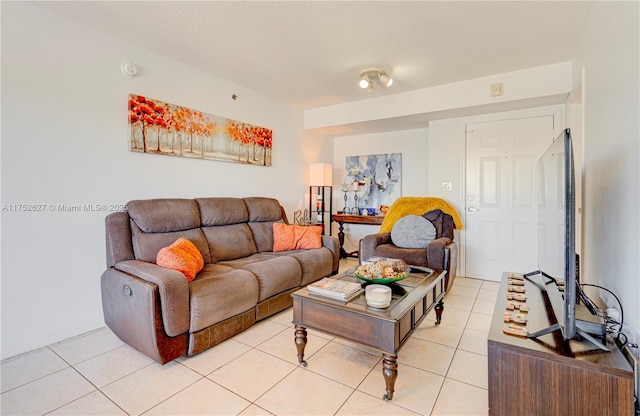 living room with a textured ceiling and light tile patterned flooring