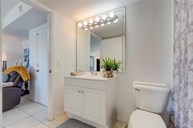 ensuite bathroom featuring ensuite bath, vanity, toilet, and tile patterned floors