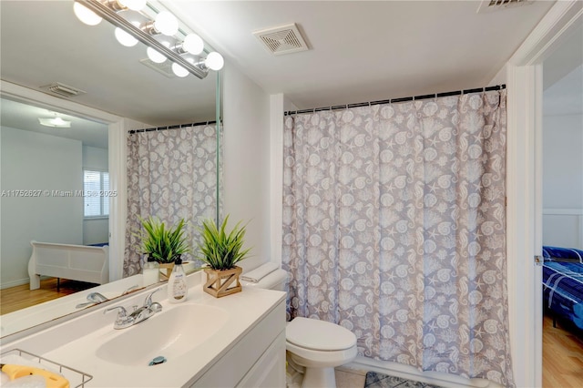 bathroom featuring visible vents, vanity, and toilet