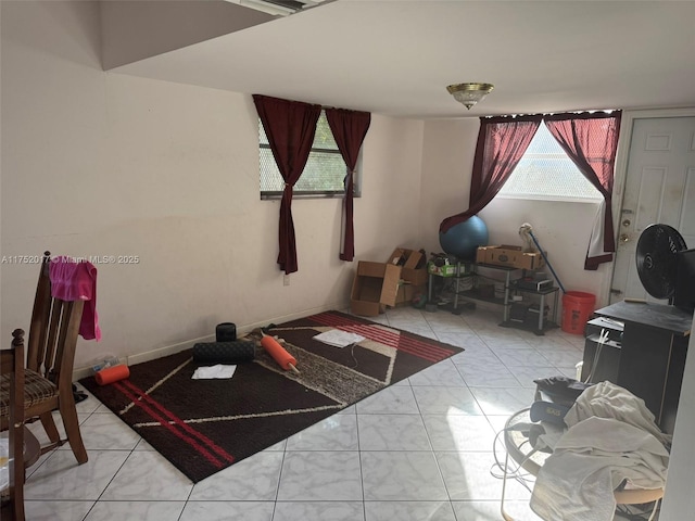 workout room with light tile patterned floors