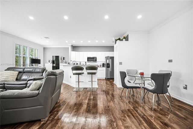 4704 SW 160th Ave Unit 224, Miramar, FL 33027 - living area featuring ornamental molding, recessed lighting, dark wood-style floors, and baseboards