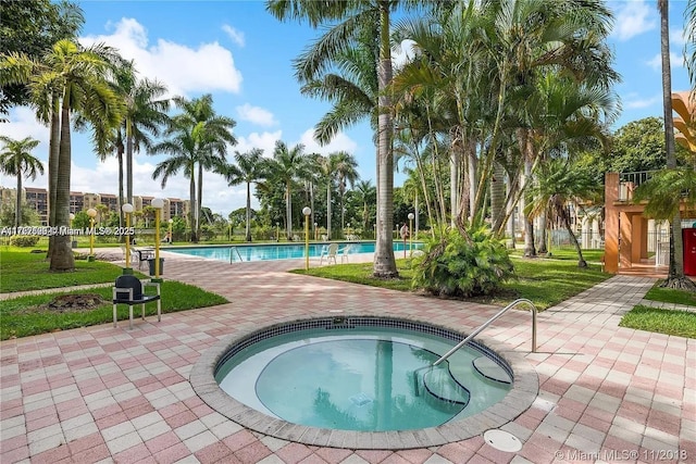 community pool featuring a patio area and a hot tub