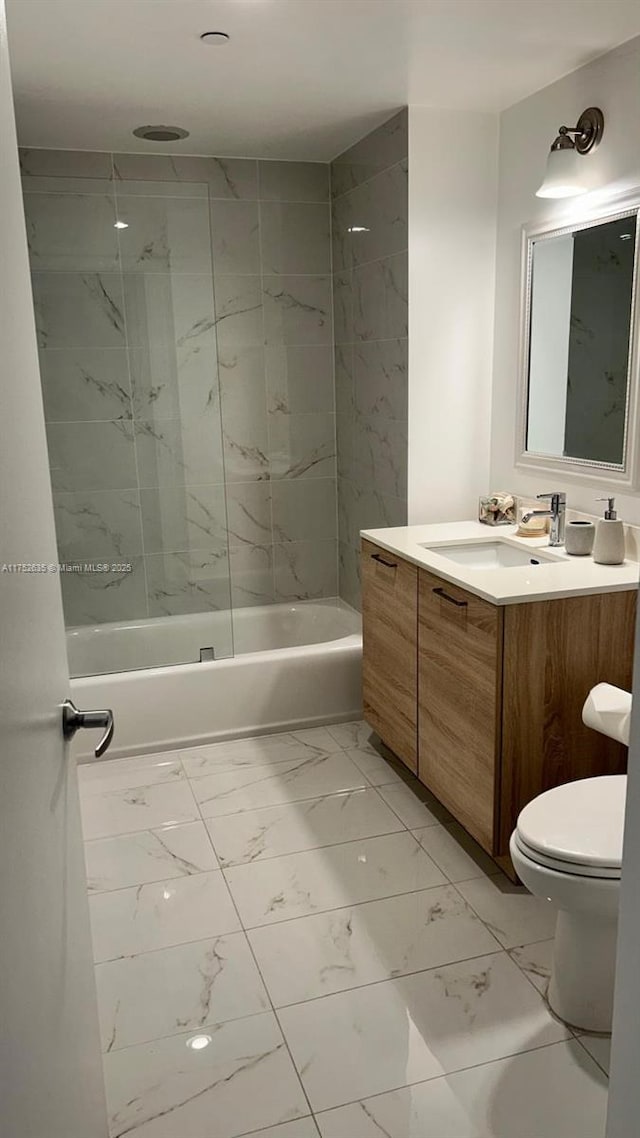 full bath featuring toilet, marble finish floor, shower / bathing tub combination, and vanity