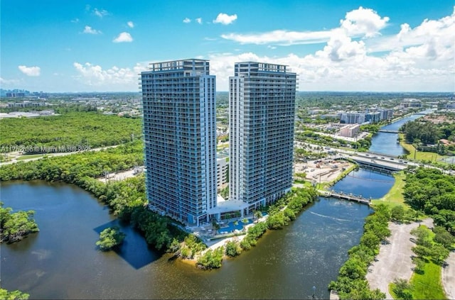 birds eye view of property featuring a water view and a city view