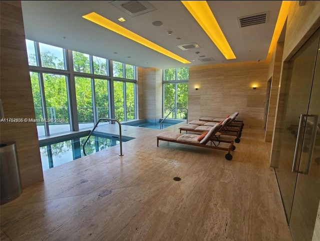 view of swimming pool featuring an indoor hot tub