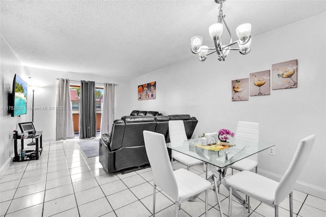 dining space with light tile patterned floors, a textured ceiling, baseboards, and an inviting chandelier