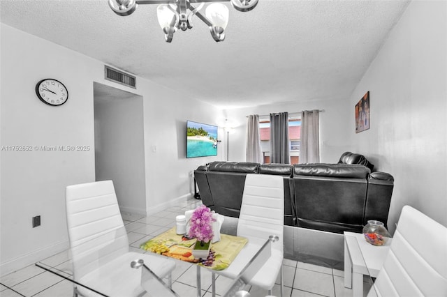 dining area featuring visible vents, a textured ceiling, baseboards, and light tile patterned floors