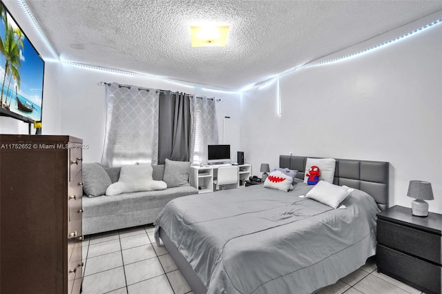 bedroom featuring a textured ceiling and tile patterned flooring