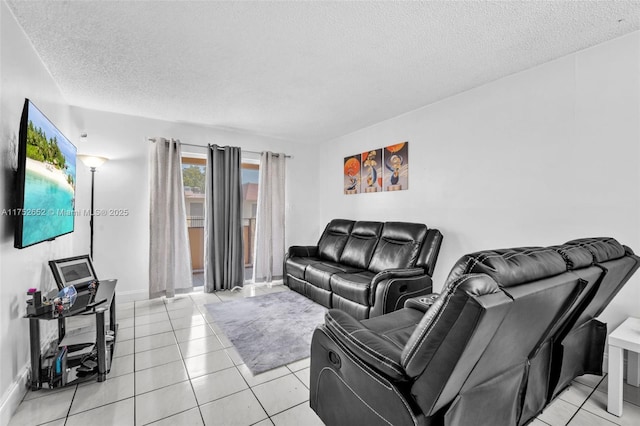 living area featuring light tile patterned floors, a textured ceiling, and baseboards