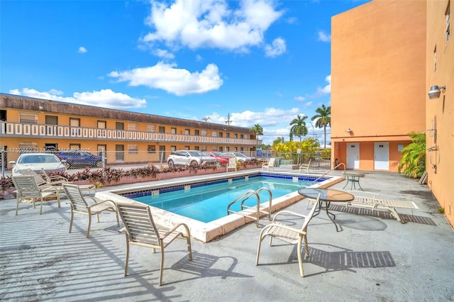 pool featuring a patio area and fence