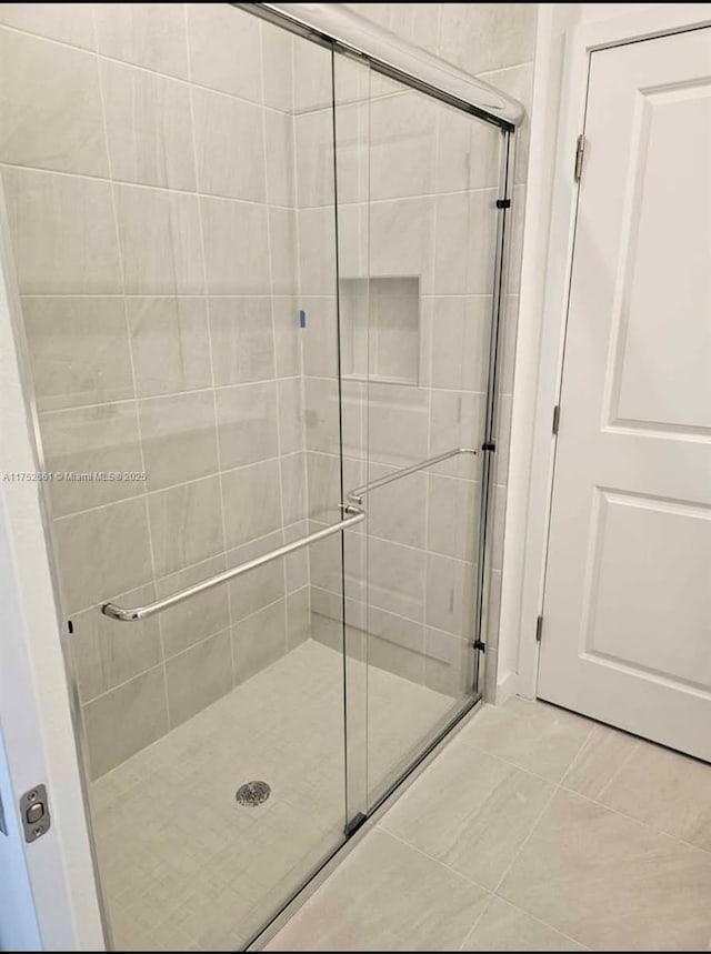 bathroom featuring a stall shower and tile patterned flooring