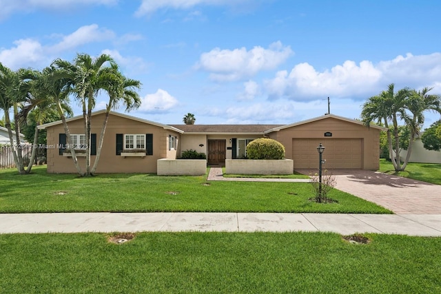 ranch-style home with a front lawn, decorative driveway, an attached garage, and stucco siding