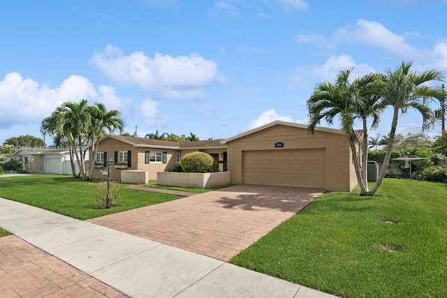 ranch-style home with a garage, a front lawn, decorative driveway, and stucco siding