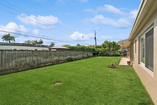 view of yard with a gazebo, a patio area, and a fenced backyard