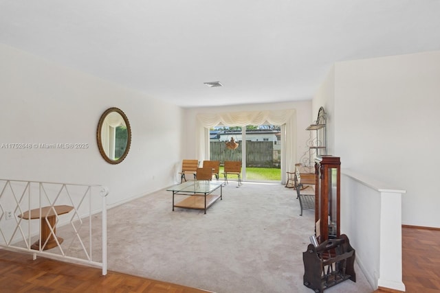 living area with visible vents and baseboards