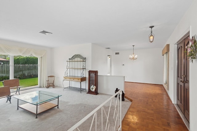 living area featuring visible vents and an inviting chandelier