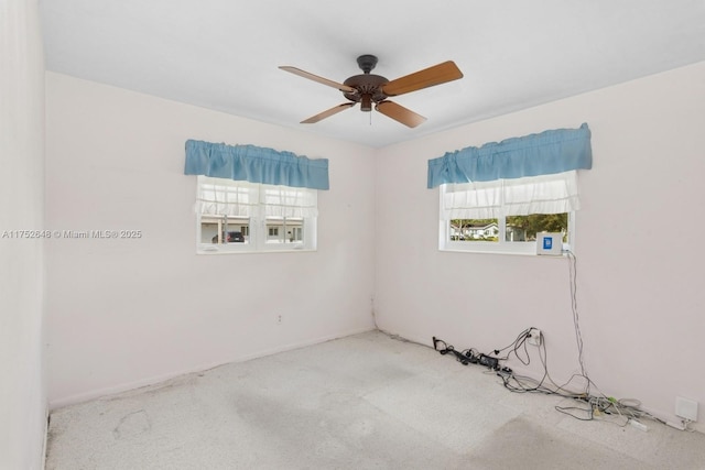 carpeted empty room featuring a ceiling fan