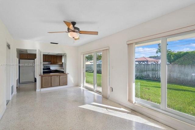 kitchen with light speckled floor, refrigerator, electric stove, and visible vents