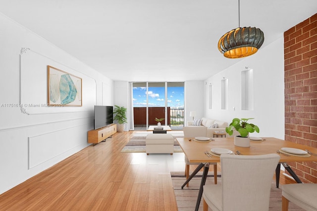 living area with light wood finished floors and a wall of windows